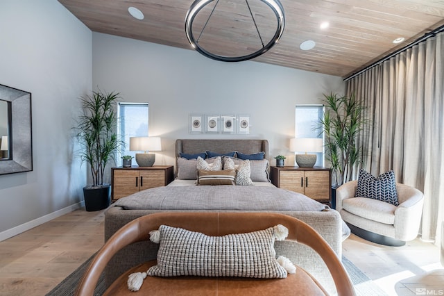 bedroom featuring vaulted ceiling, light wood finished floors, wooden ceiling, and baseboards