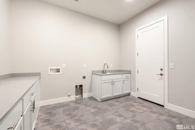 clothes washing area with hookup for a washing machine, hookup for a gas dryer, a sink, baseboards, and electric dryer hookup