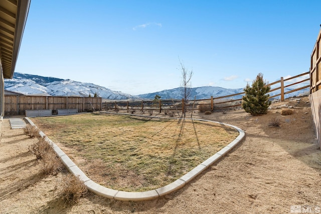 view of yard featuring a fenced backyard and a mountain view