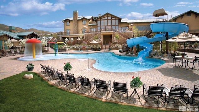 view of pool with a mountain view and a water slide