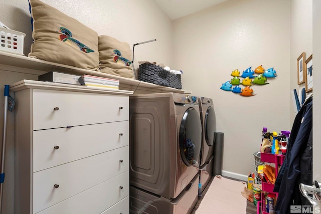 washroom featuring baseboards, laundry area, and washer and dryer