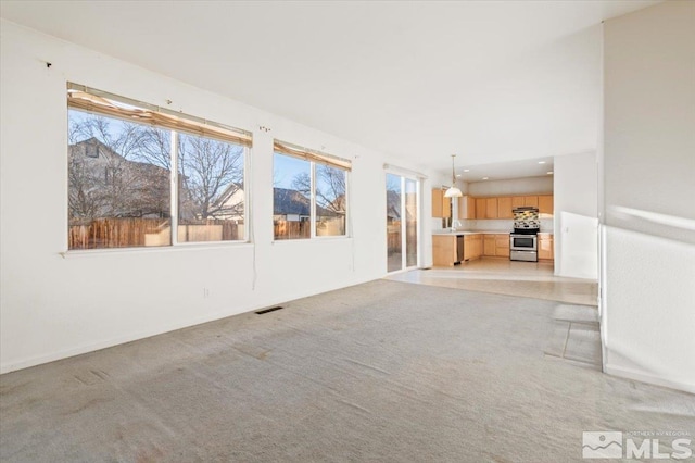 unfurnished living room with light carpet and visible vents