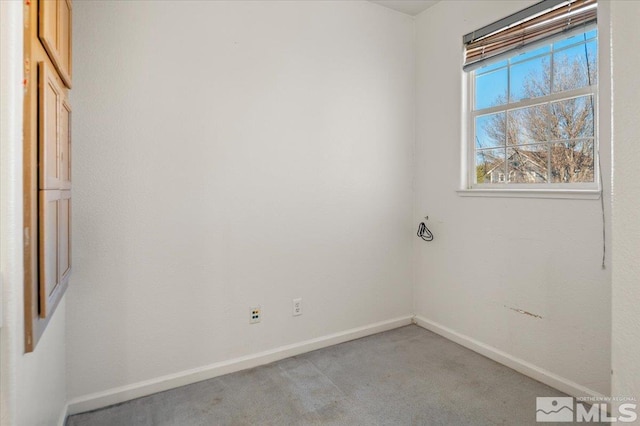 empty room with light carpet and baseboards