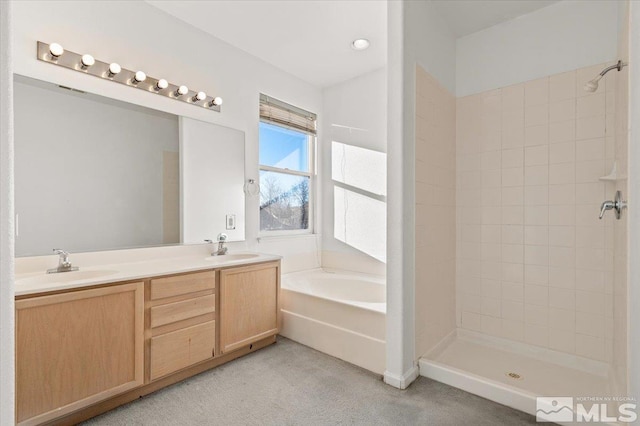 bathroom with a sink, carpet flooring, a bath, and a tile shower