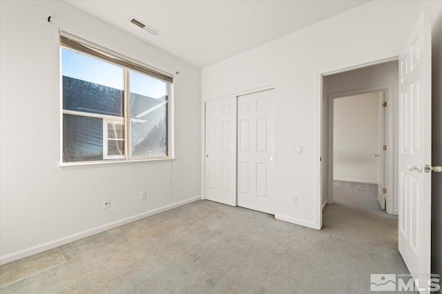 unfurnished bedroom with light carpet, baseboards, and visible vents