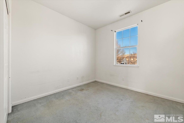 unfurnished room featuring baseboards, visible vents, and light colored carpet