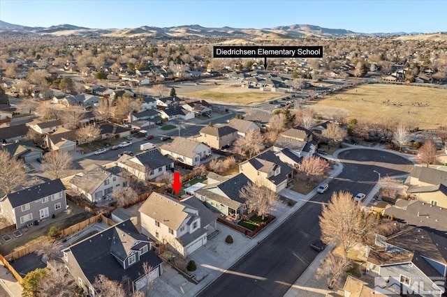 drone / aerial view with a residential view and a mountain view