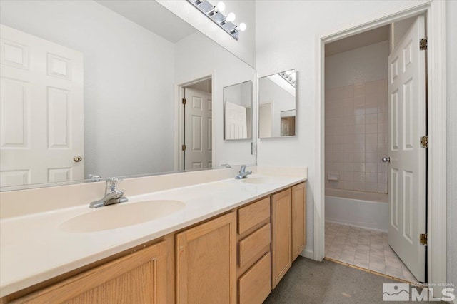 bathroom with shower / bathtub combination, double vanity, tile patterned flooring, and a sink