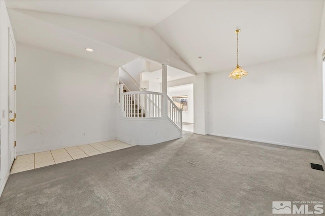 unfurnished room featuring light carpet, light tile patterned floors, visible vents, stairs, and vaulted ceiling