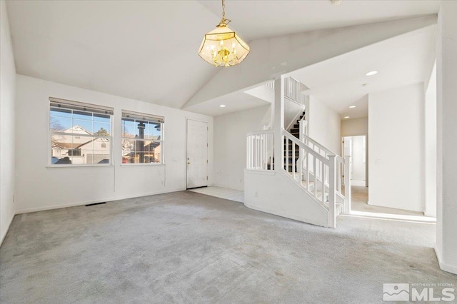 empty room with stairs, high vaulted ceiling, light carpet, and recessed lighting