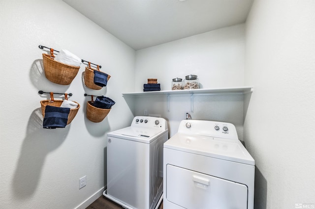 laundry room featuring laundry area, washing machine and dryer, dark wood finished floors, and baseboards