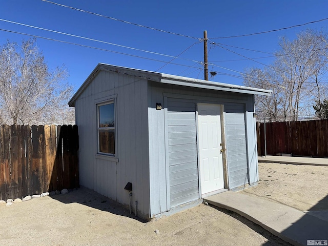 view of outbuilding with an outdoor structure and a fenced backyard