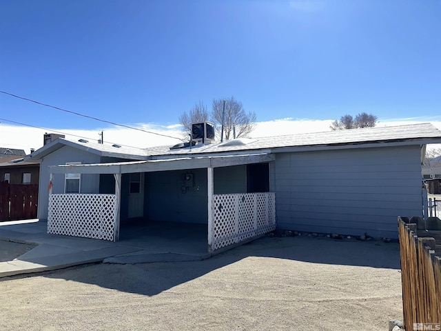 rear view of property featuring fence and cooling unit