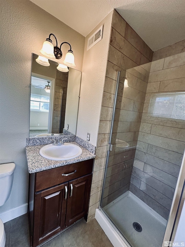 bathroom featuring visible vents, toilet, tile patterned flooring, vanity, and a shower stall