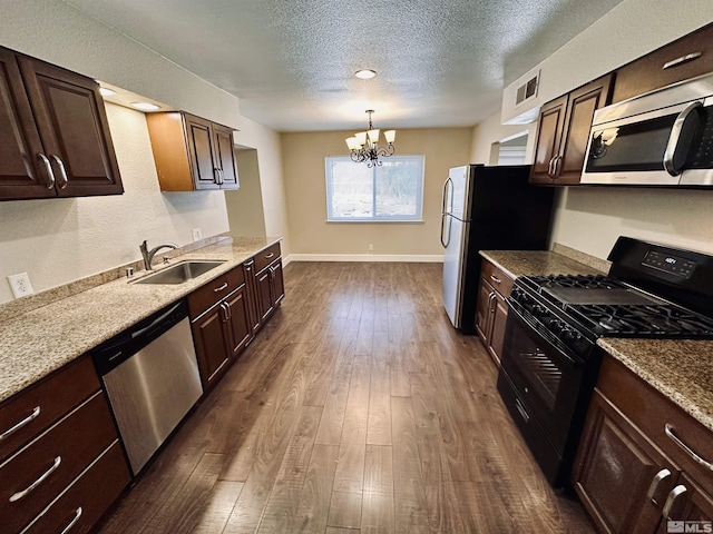 kitchen featuring dark brown cabinetry, stainless steel appliances, and a sink