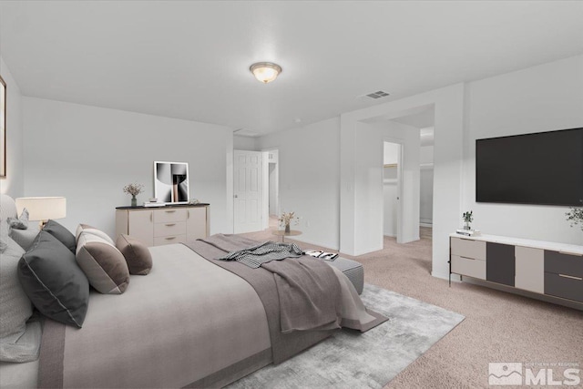 bedroom featuring visible vents and light carpet