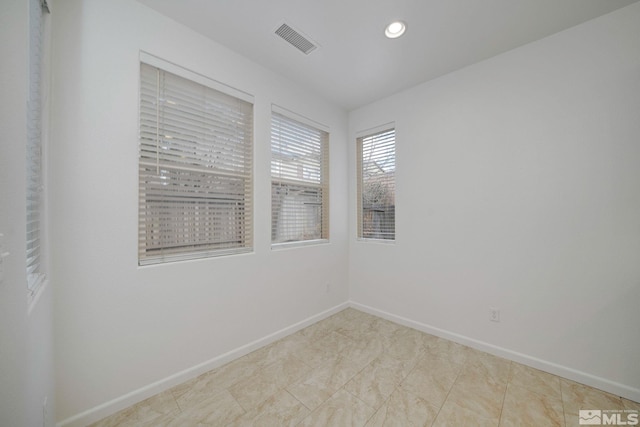 unfurnished room featuring recessed lighting, visible vents, and baseboards