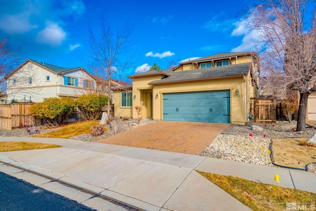 view of front of house featuring a garage, decorative driveway, fence, and stucco siding