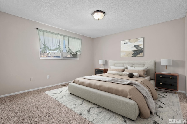 carpeted bedroom featuring a textured ceiling and baseboards