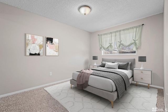 carpeted bedroom with a textured ceiling and baseboards