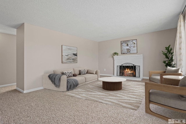 living area featuring a brick fireplace, carpet, baseboards, and a textured ceiling