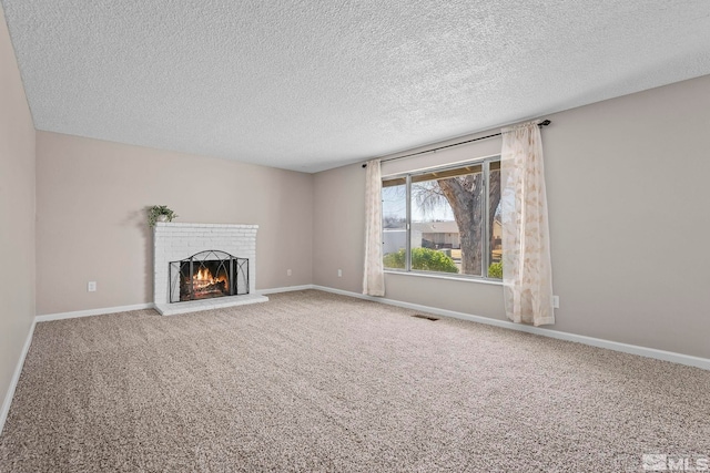 unfurnished living room featuring carpet, a brick fireplace, visible vents, and baseboards