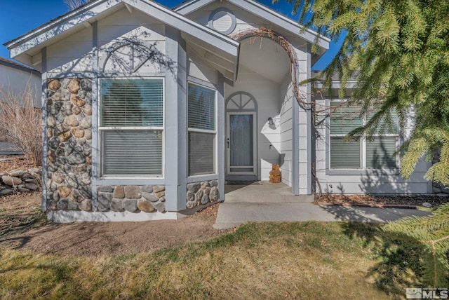 view of exterior entry with stone siding