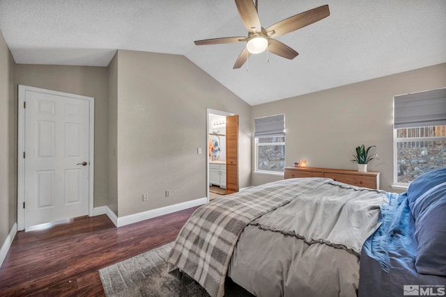 bedroom featuring a ceiling fan, vaulted ceiling, a textured ceiling, wood finished floors, and baseboards