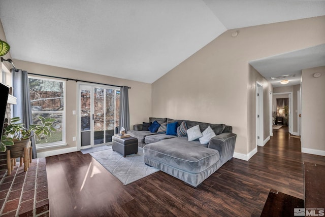 living area with vaulted ceiling, wood finished floors, and baseboards