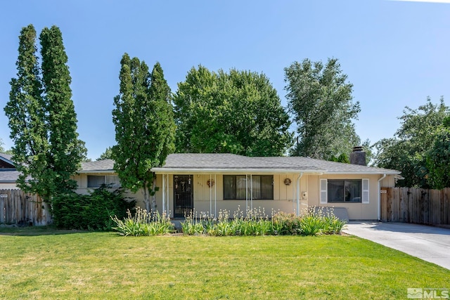 single story home with a chimney, fence, concrete driveway, and a front yard