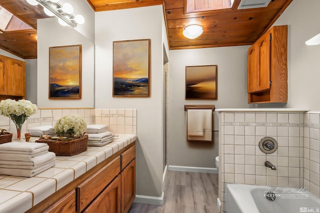 bathroom featuring toilet, wood ceiling, a bath, and wood finished floors