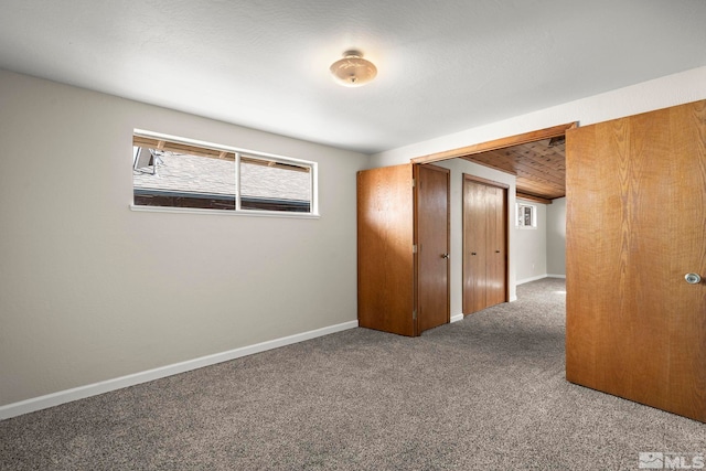 unfurnished bedroom featuring carpet and baseboards