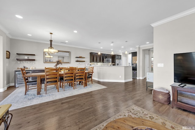 dining room with dark wood-style floors, recessed lighting, ornamental molding, and baseboards