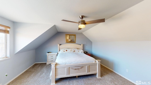 carpeted bedroom with vaulted ceiling, ceiling fan, and baseboards