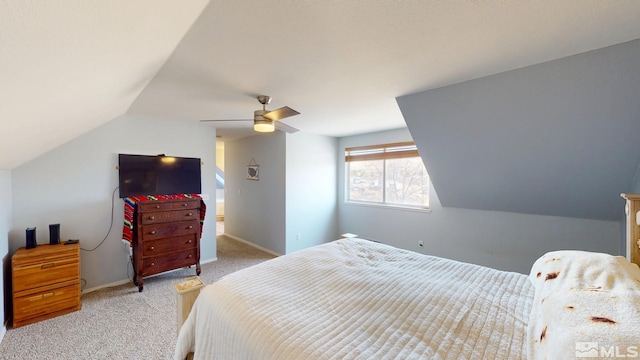 bedroom with carpet floors, vaulted ceiling, baseboards, and a ceiling fan