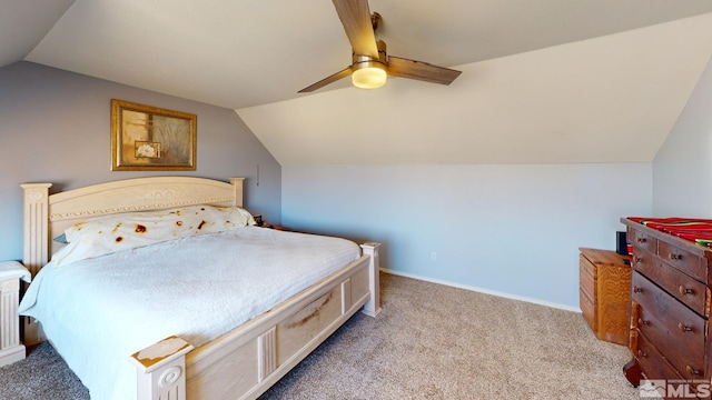 carpeted bedroom with baseboards, vaulted ceiling, and a ceiling fan