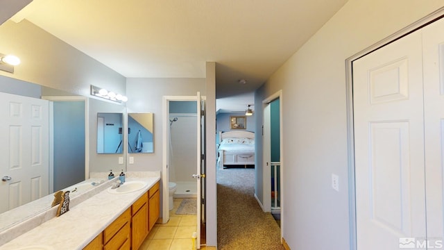 full bathroom with toilet, tile patterned flooring, double vanity, and a shower