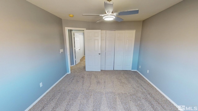 unfurnished bedroom with carpet floors, a closet, ceiling fan, and baseboards