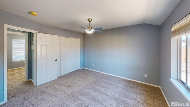 unfurnished bedroom featuring carpet and multiple windows