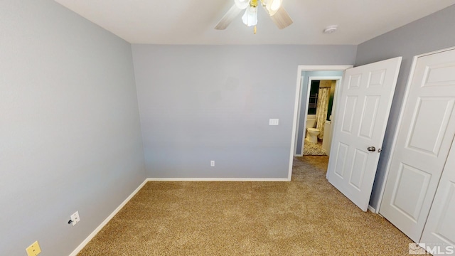 unfurnished bedroom featuring carpet floors, a ceiling fan, and baseboards