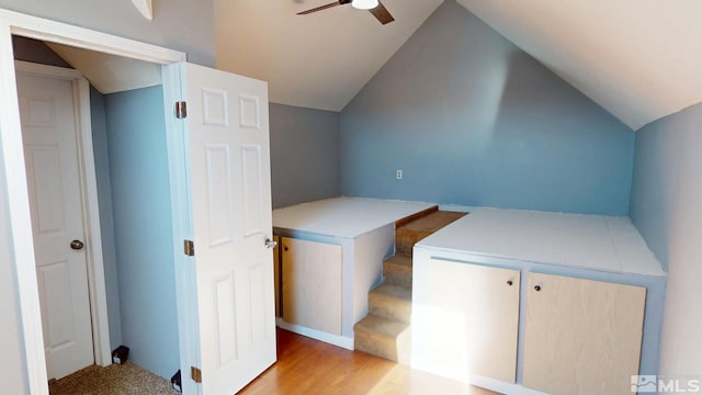 bonus room with a ceiling fan, vaulted ceiling, and light wood finished floors