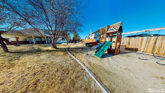 view of jungle gym with a yard and fence