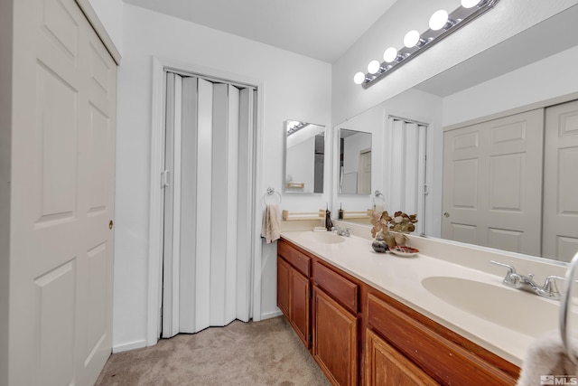 bathroom with a sink and double vanity