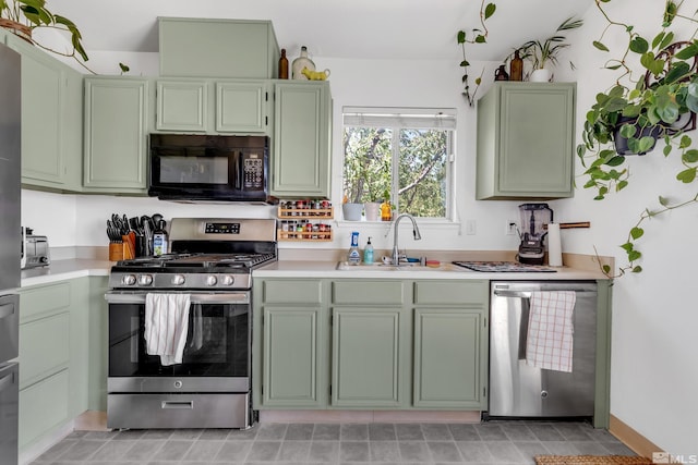 kitchen featuring stainless steel appliances, light countertops, and green cabinets