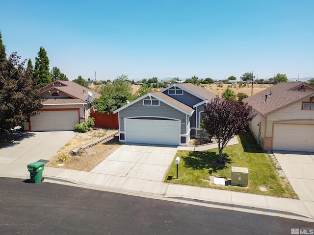 view of front of property with a garage, concrete driveway, a front lawn, and fence