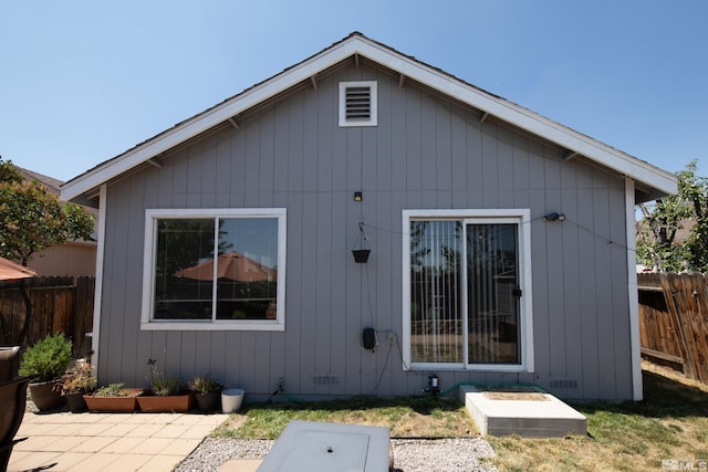 back of house with crawl space, a patio area, and fence