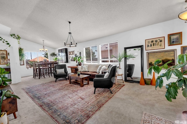 living room with carpet floors, lofted ceiling, a notable chandelier, and a textured ceiling