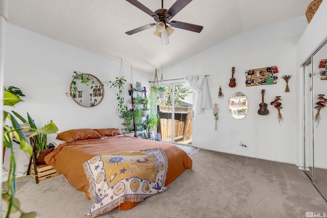 bedroom with a textured ceiling, carpet floors, vaulted ceiling, access to outside, and a closet