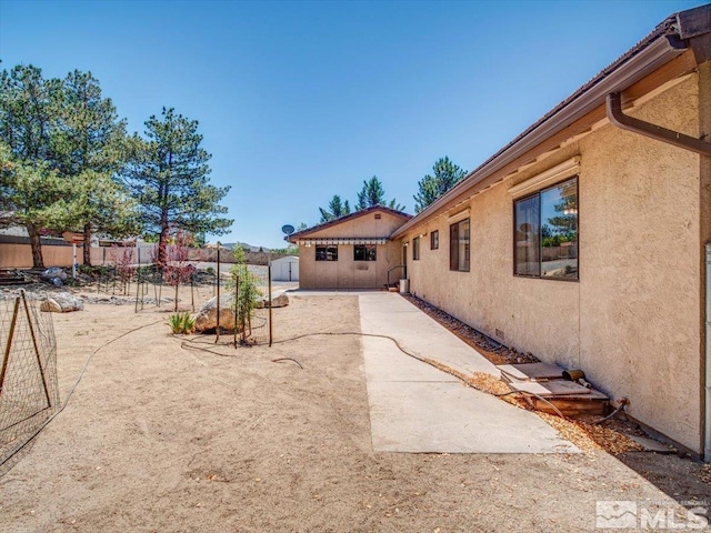 view of yard featuring fence and a patio