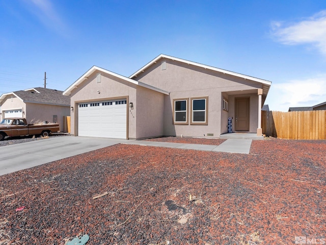 ranch-style home with driveway, fence, an attached garage, and stucco siding